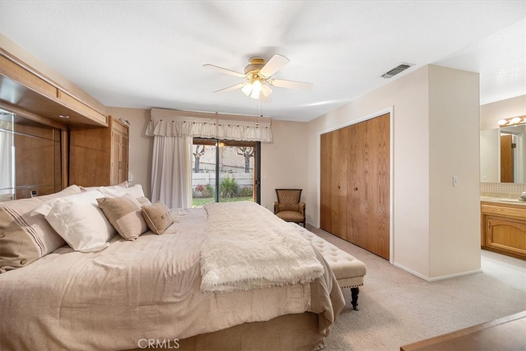 834 Nicklaus Street Paso Robles, CA 93446 - Photo 14 of 37 a bedroom with a large bed and a chandelier