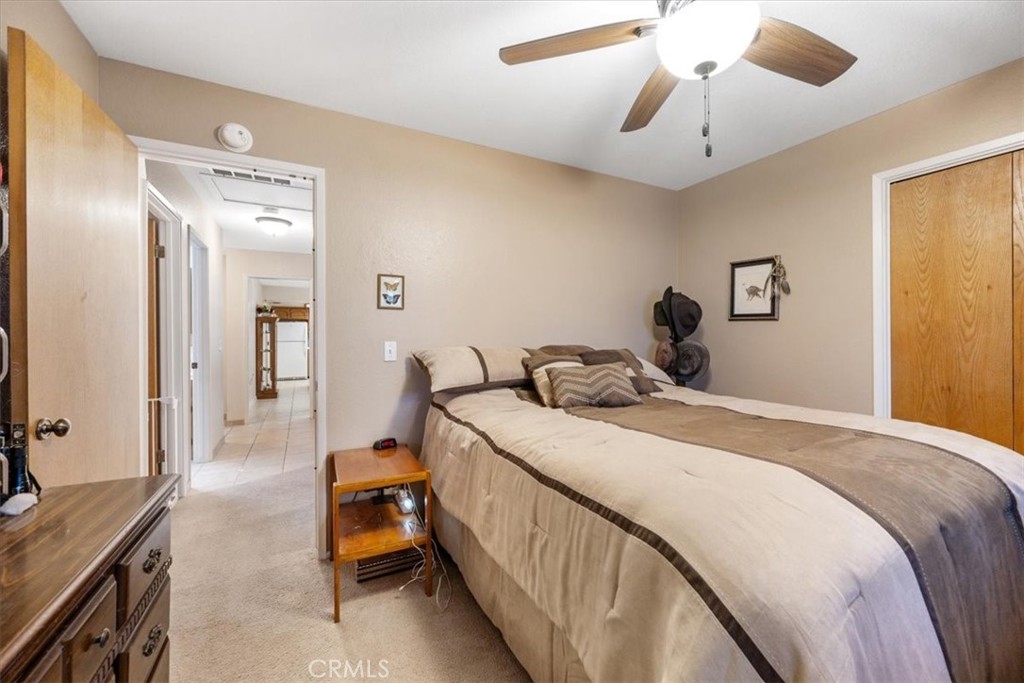 834 Nicklaus Street Paso Robles, CA 93446 - Photo 18 of 37 a bedroom with a bed and a chandelier