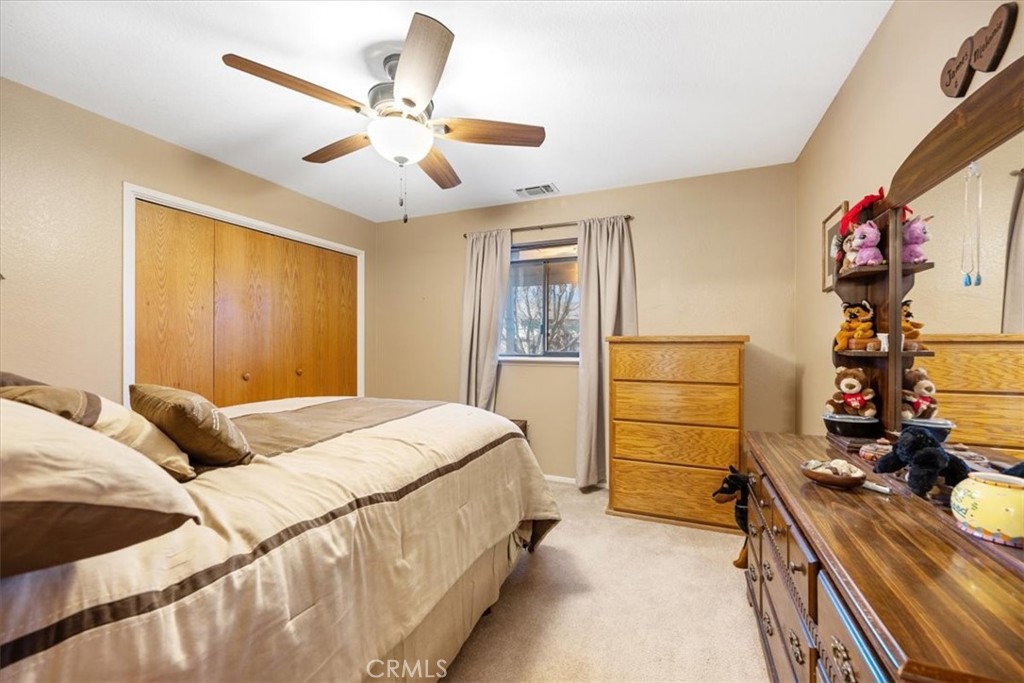 834 Nicklaus Street Paso Robles, CA 93446 - Photo 19 of 37 a bedroom with a bed and a chandelier