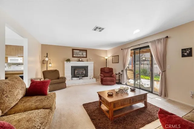 a living room with furniture large window and a fireplace