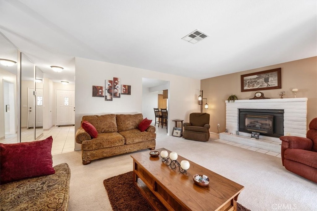 834 Nicklaus Street Paso Robles, CA 93446 - Photo 4 of 37 a living room with furniture and a fireplace