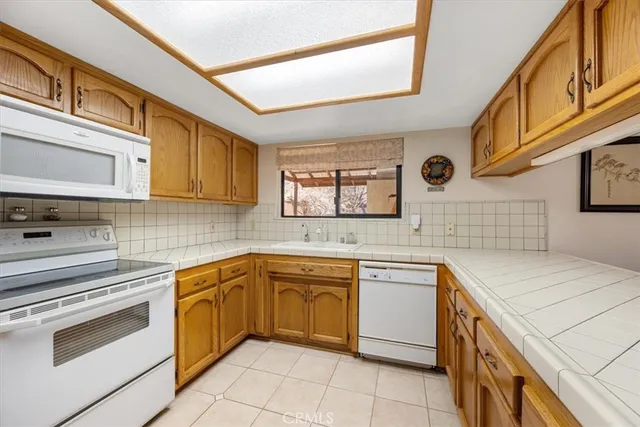 a kitchen with a stove sink and cabinets