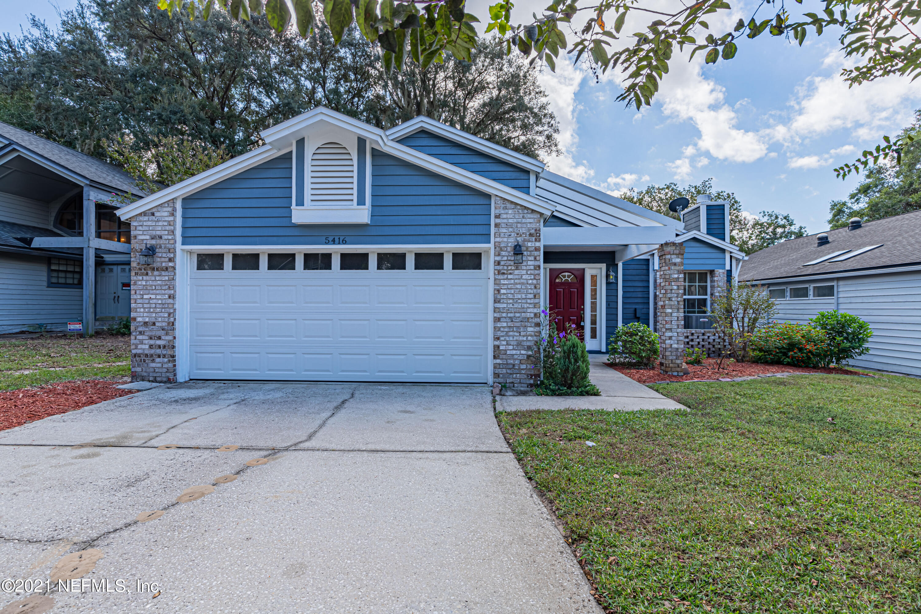 5416 Spring Brook Road Jacksonville, FL 32277 - Photo 1 of 27 a front view of a house with garden