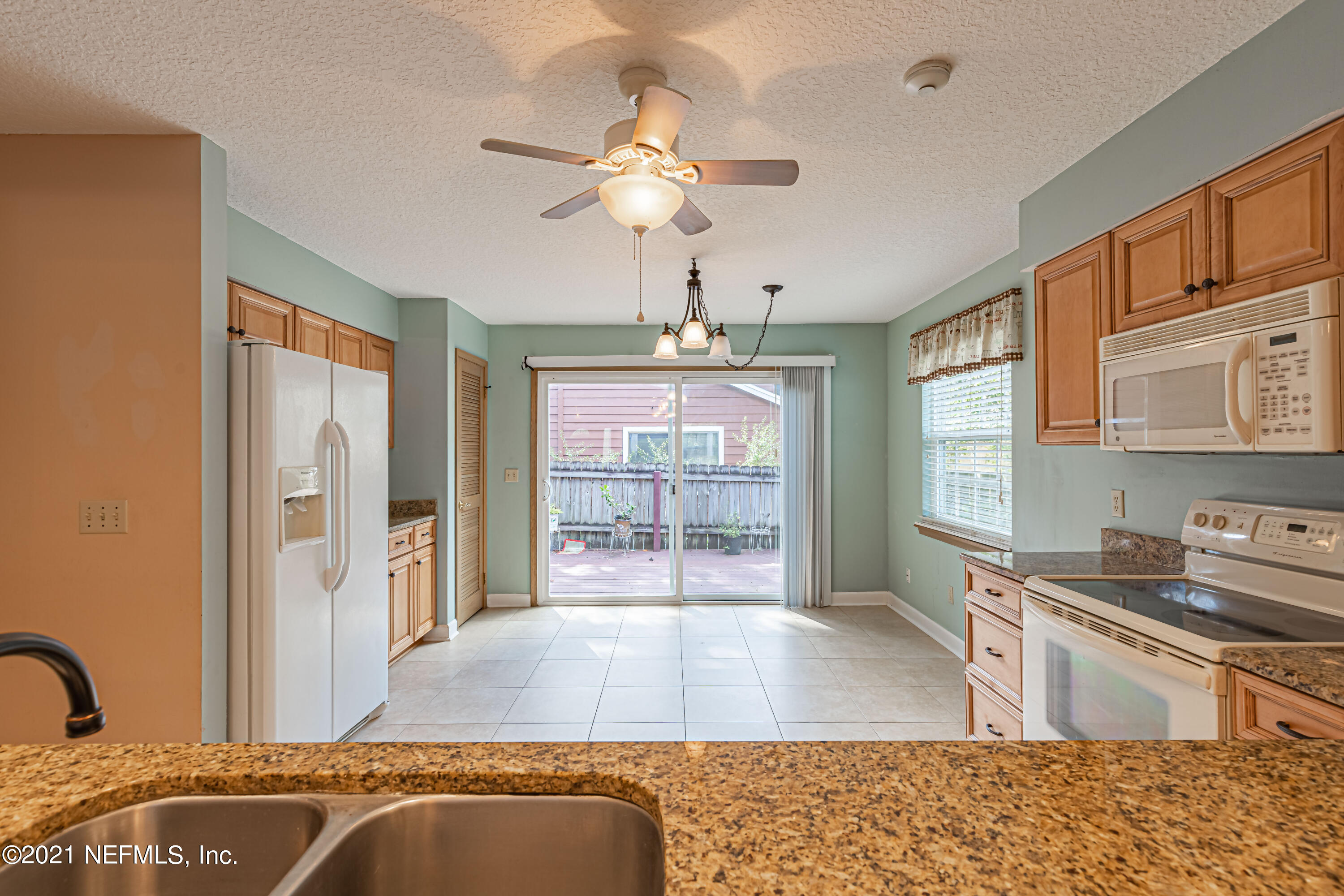 5416 Spring Brook Road Jacksonville, FL 32277 - Photo 12 of 27 a living room with stainless steel appliances granite countertop furniture a couch and a window