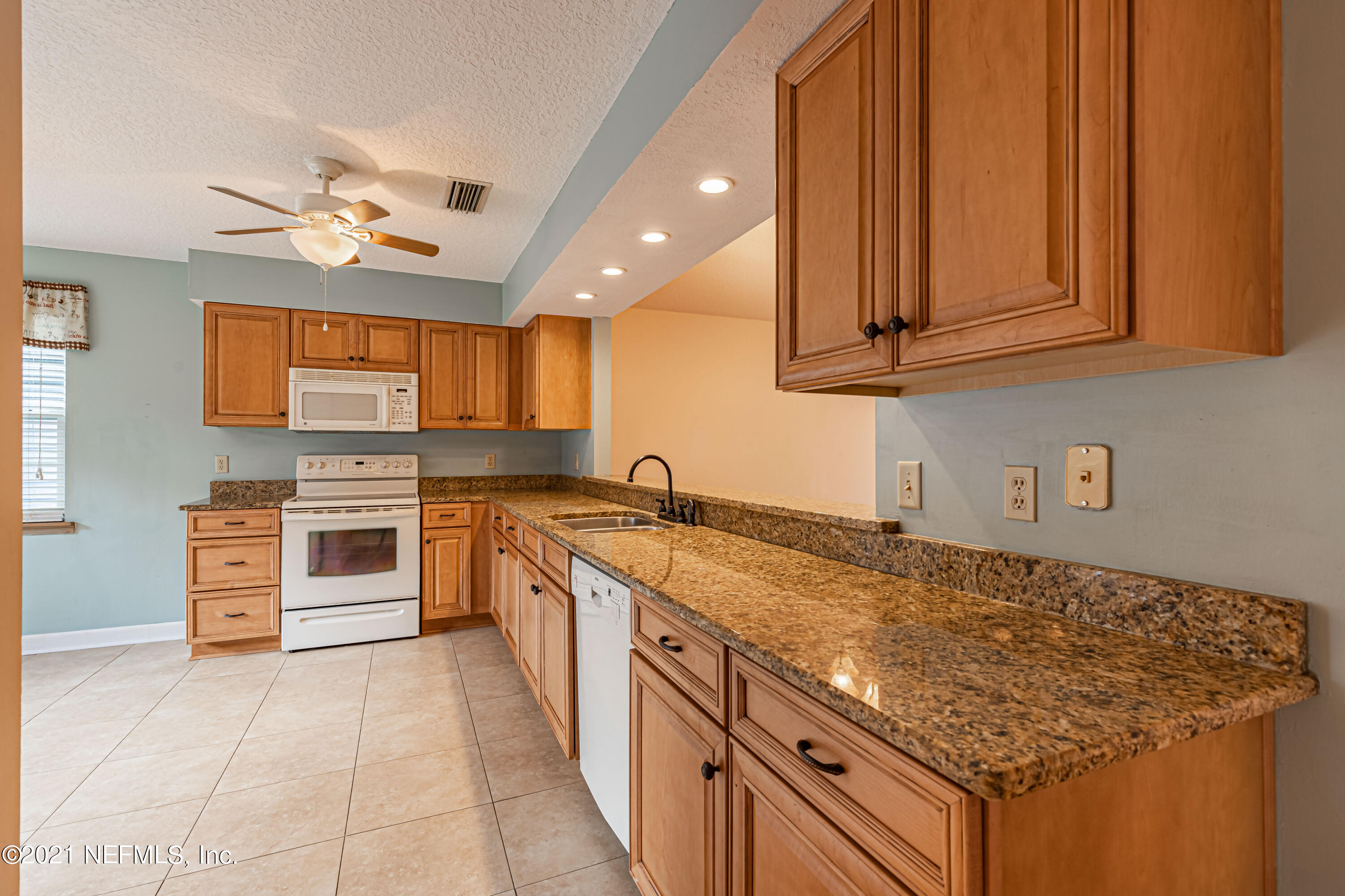 5416 Spring Brook Road Jacksonville, FL 32277 - Photo 13 of 27 a kitchen with stainless steel appliances granite countertop a stove sink and cabinets