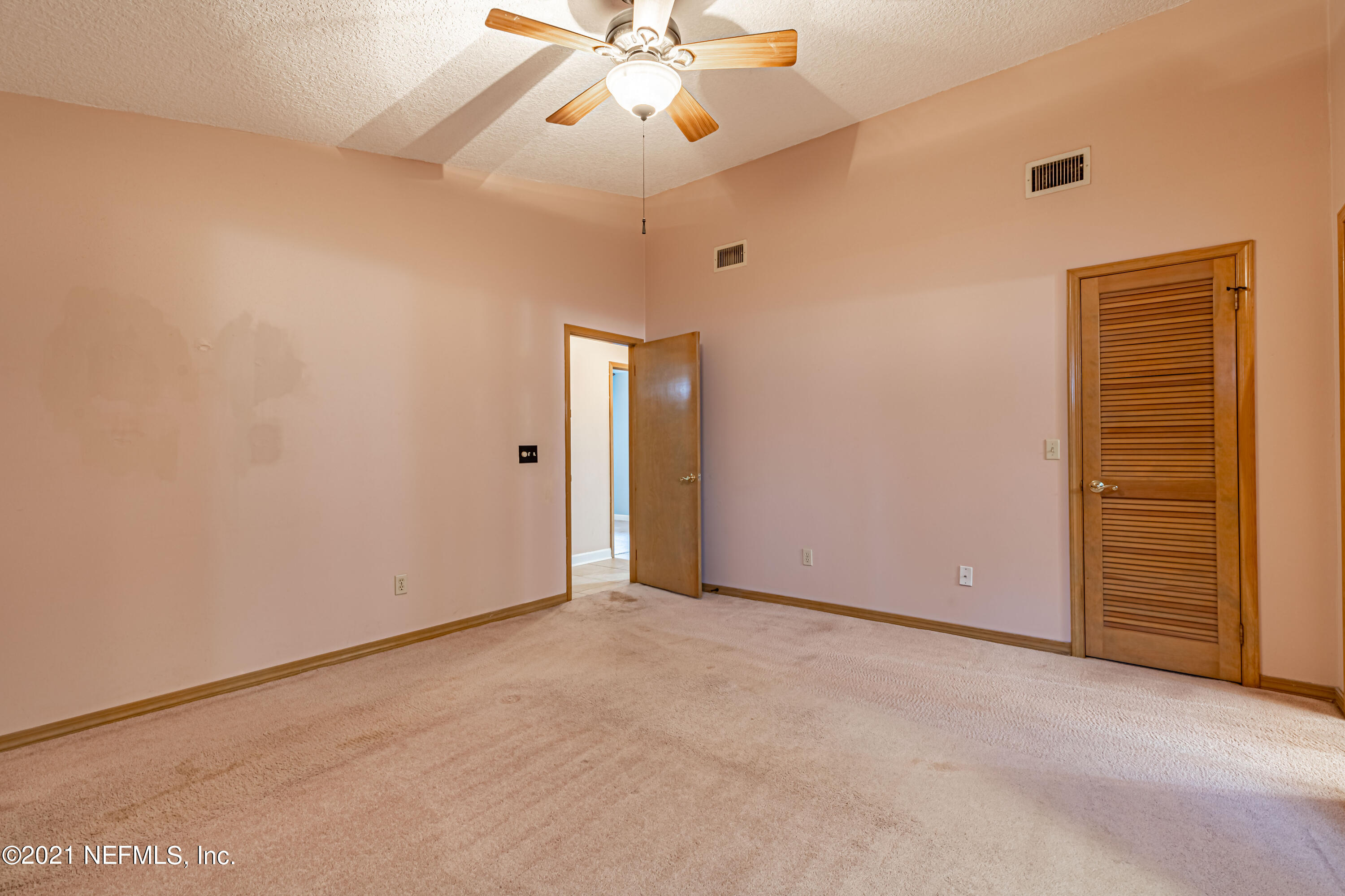 5416 Spring Brook Road Jacksonville, FL 32277 - Photo 18 of 27 an empty room with closet and a chandelier fan
