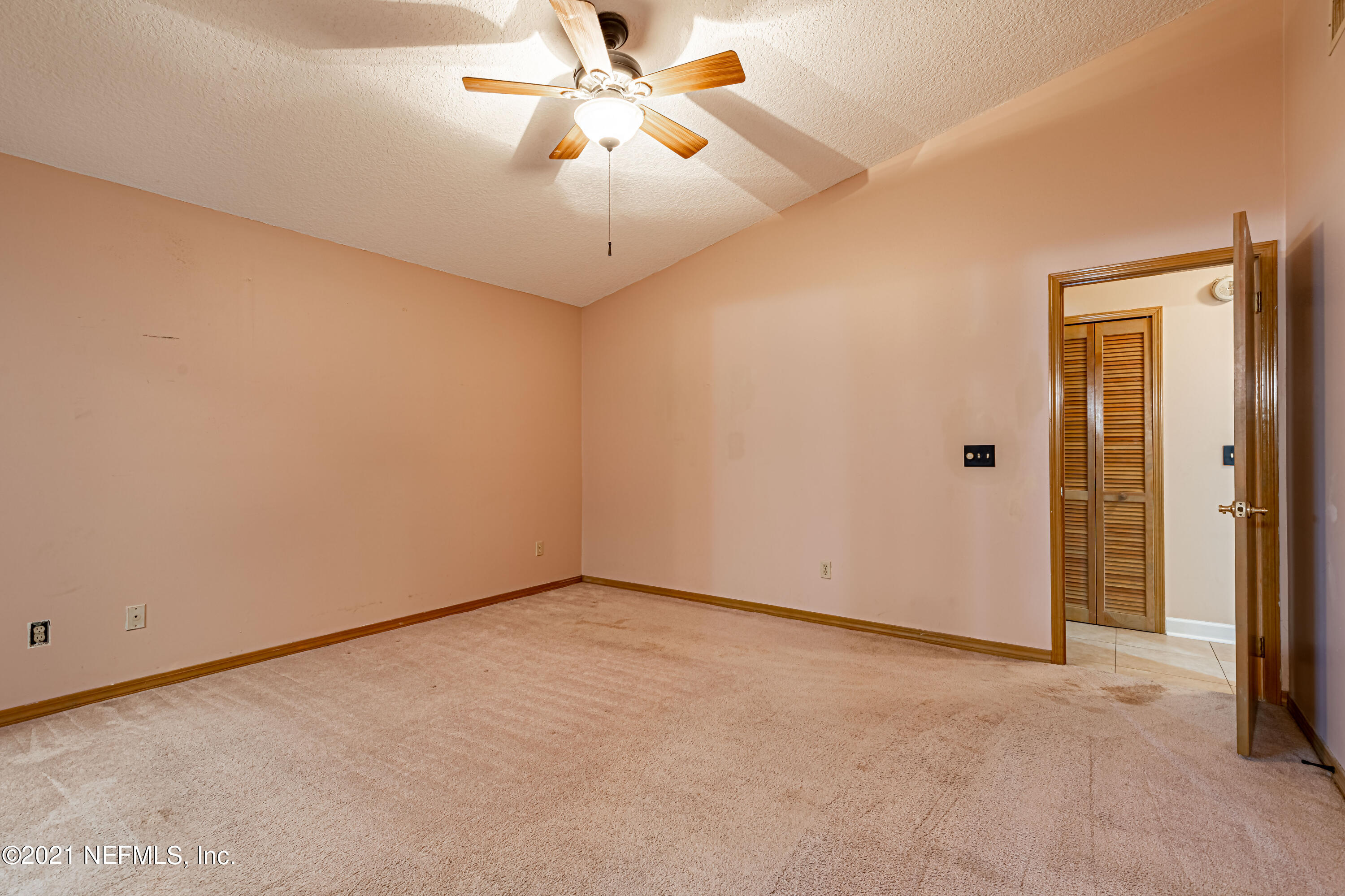 5416 Spring Brook Road Jacksonville, FL 32277 - Photo 19 of 27 an empty room with closet and a chandelier fan