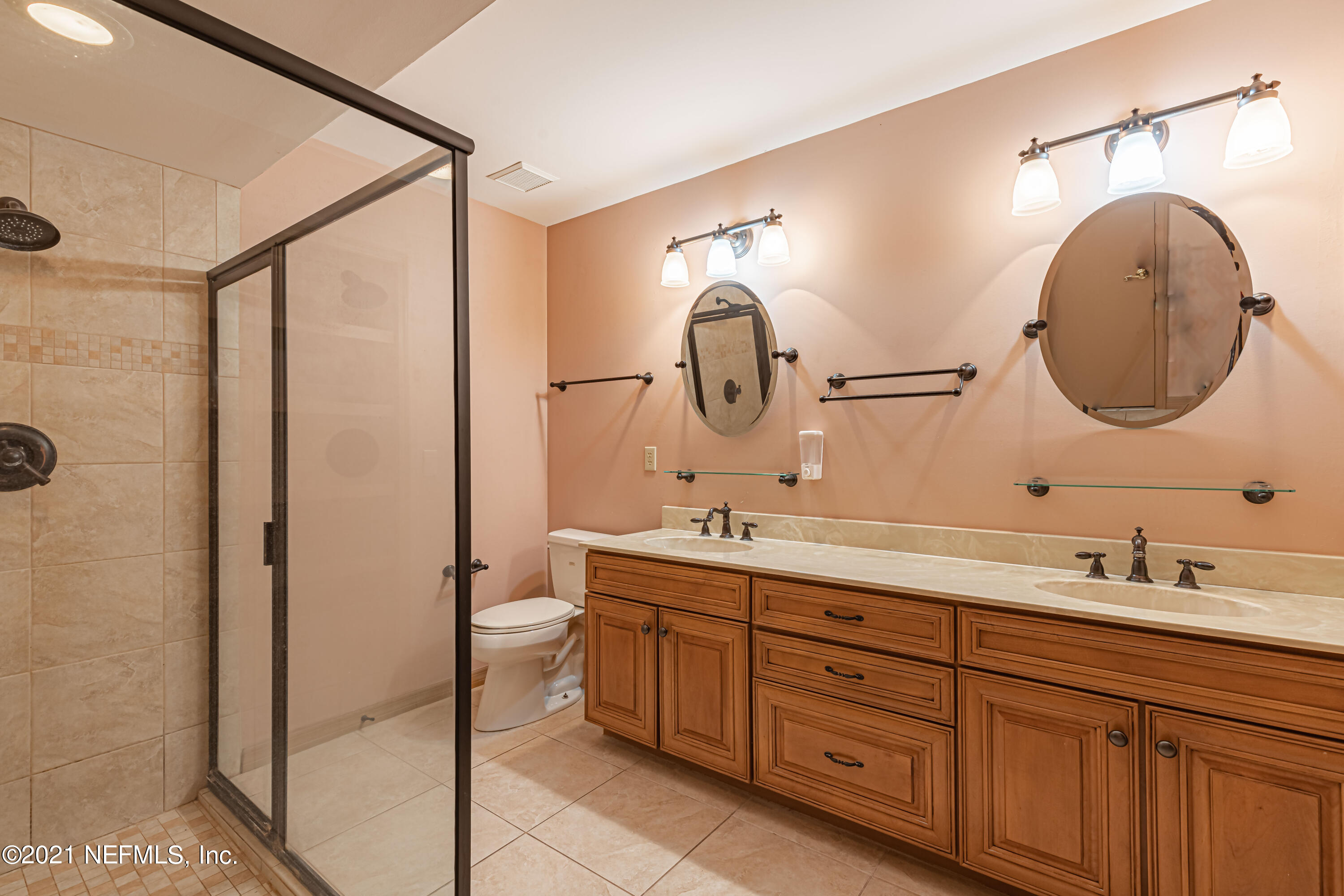 5416 Spring Brook Road Jacksonville, FL 32277 - Photo 20 of 27 a spacious bathroom with a double vanity sink and a mirror