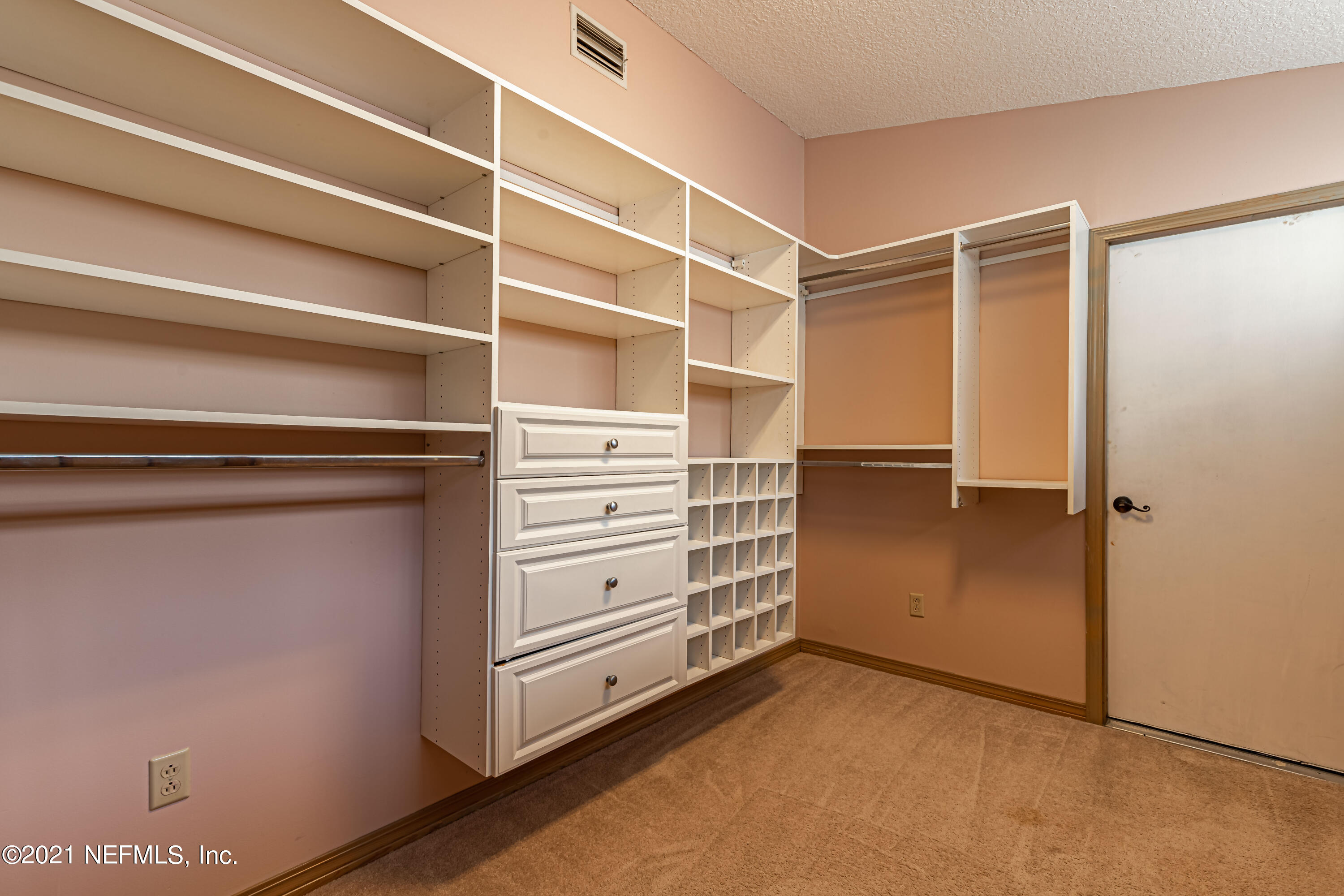 5416 Spring Brook Road Jacksonville, FL 32277 - Photo 21 of 27 a view of walk in closet with empty racks