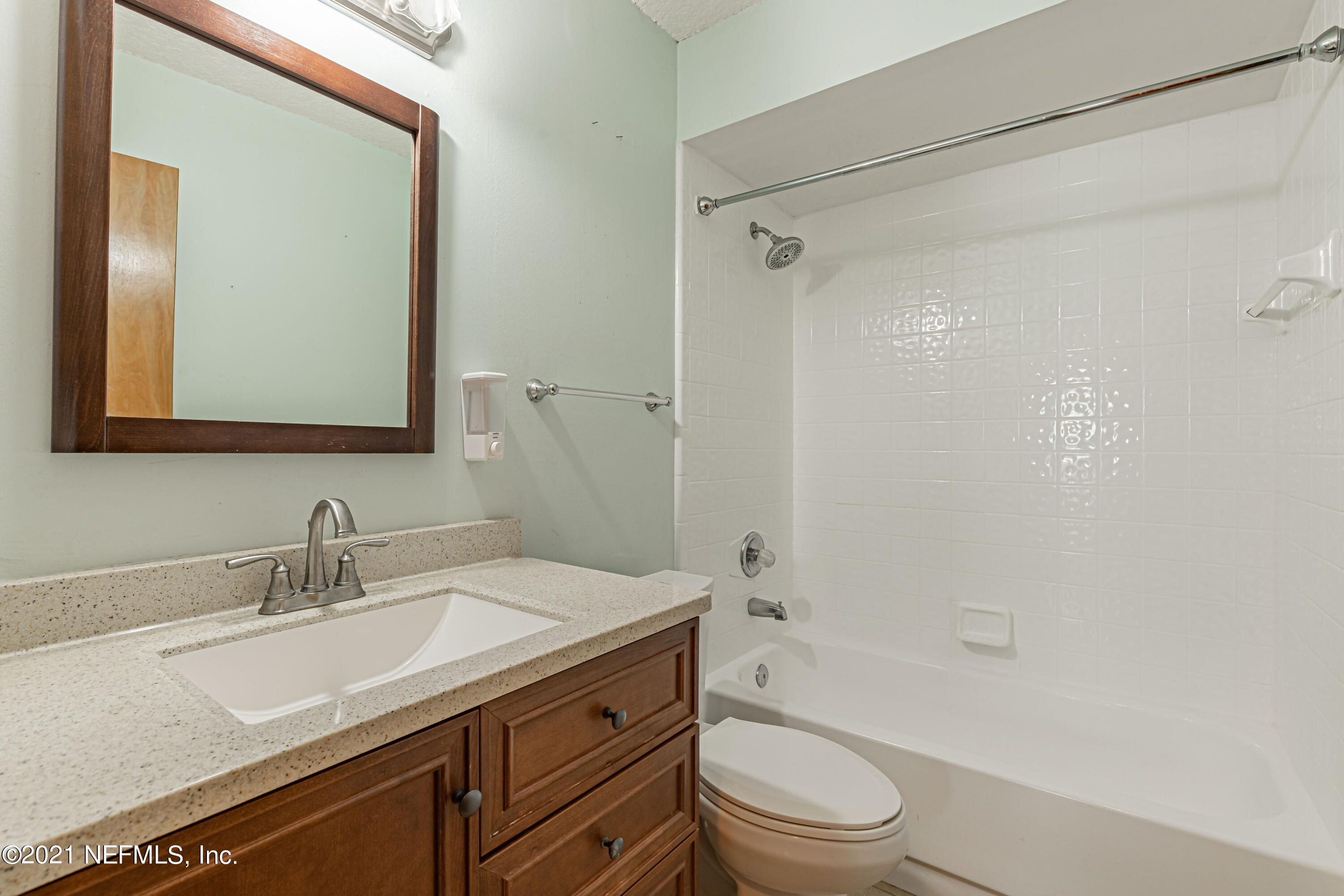 5416 Spring Brook Road Jacksonville, FL 32277 - Photo 23 of 27 a bathroom with a granite countertop sink a toilet and shower