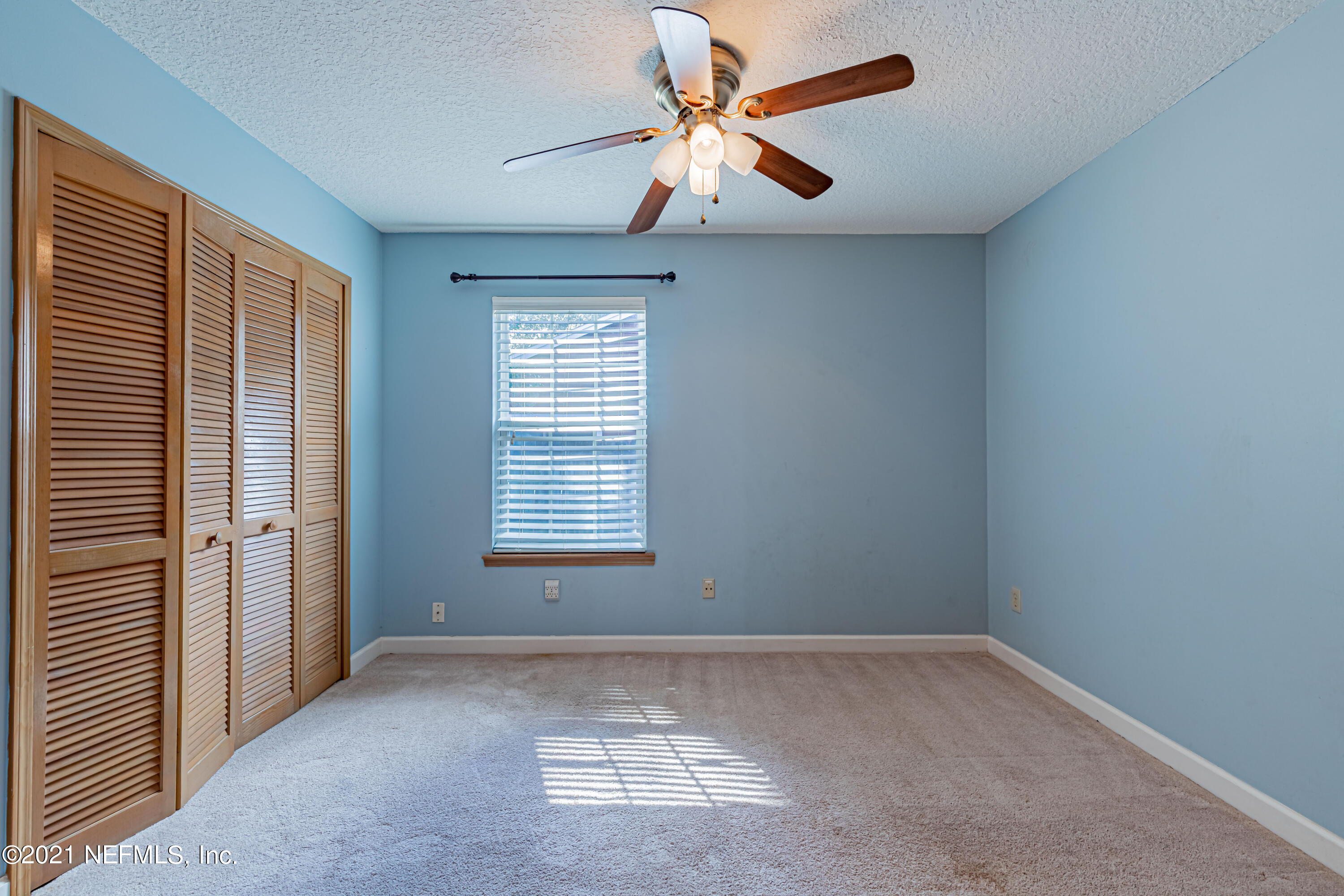 5416 Spring Brook Road Jacksonville, FL 32277 - Photo 24 of 27 an empty room with a window and a fan