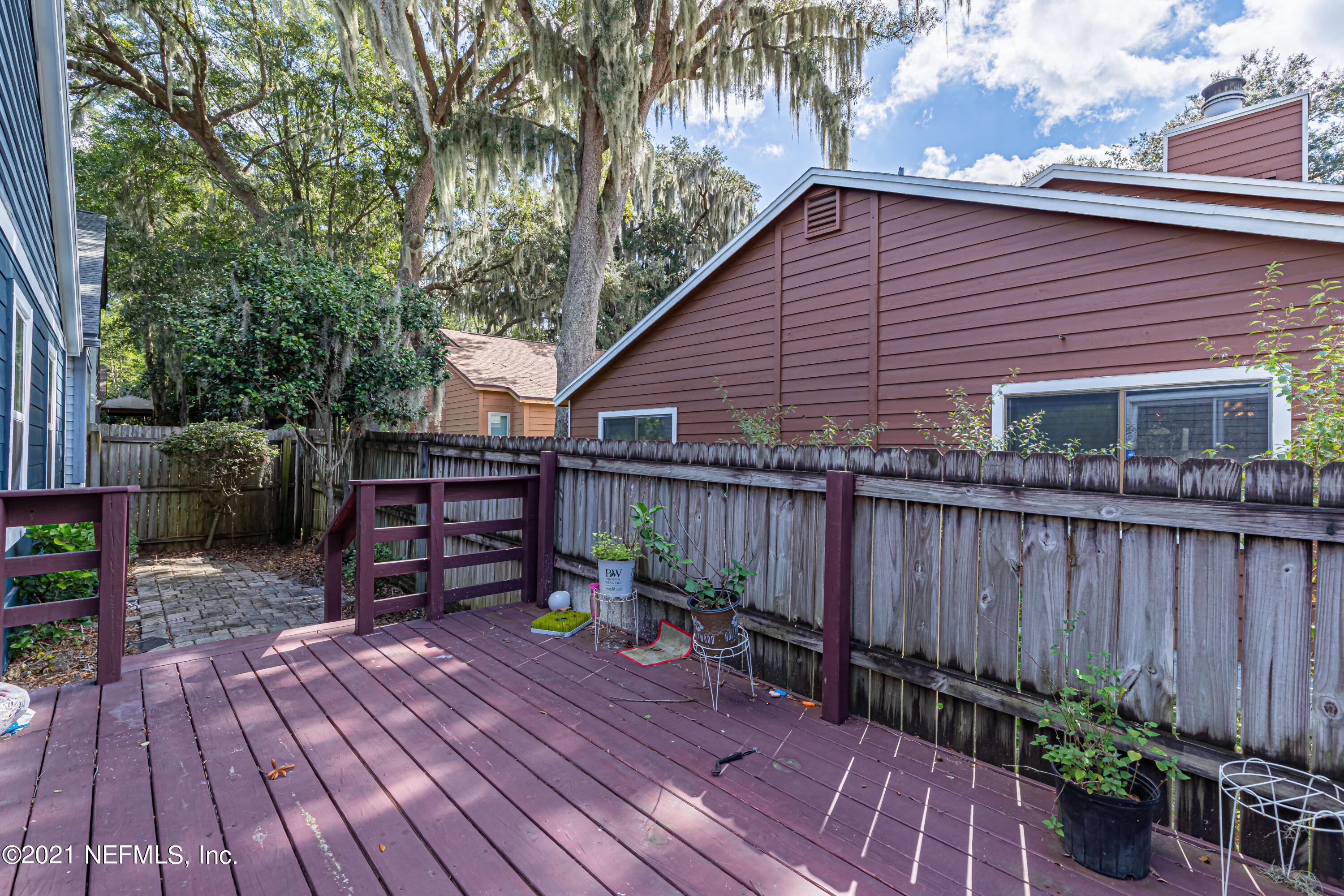 5416 Spring Brook Road Jacksonville, FL 32277 - Photo 26 of 27 a backyard of a house with potted plants and wooden fence