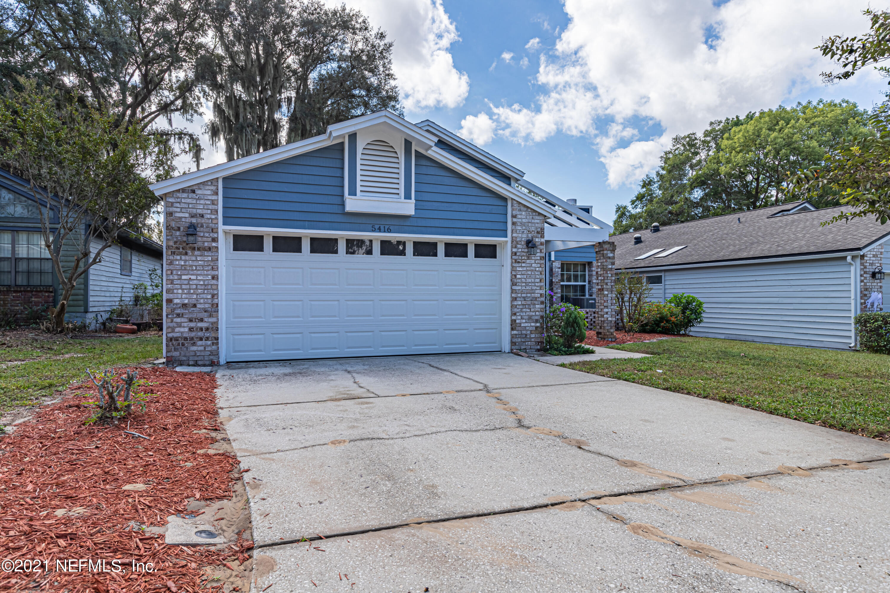 5416 Spring Brook Road Jacksonville, FL 32277 - Photo 3 of 27 a view of backyard of house with garage and entertaining space