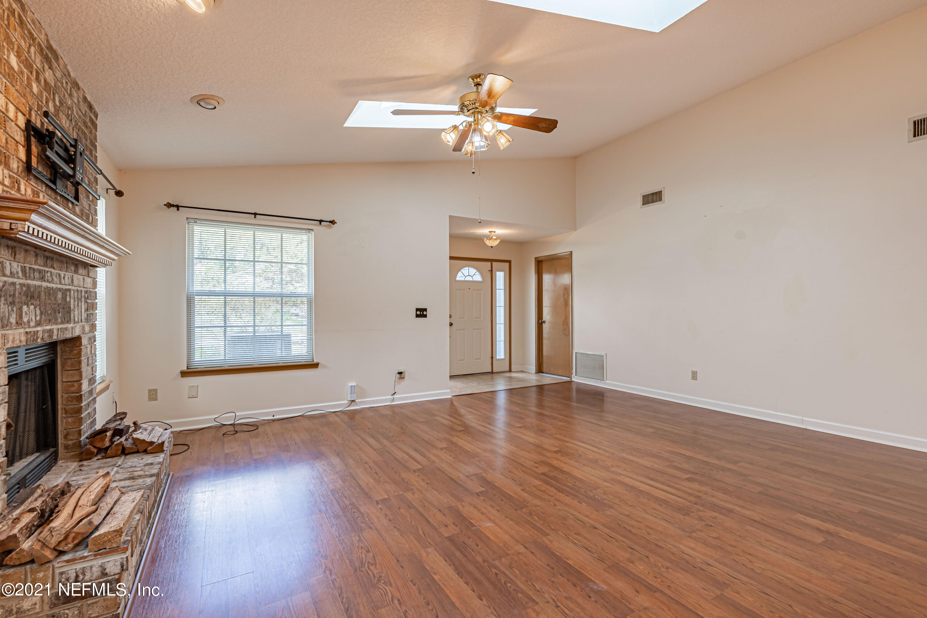 5416 Spring Brook Road Jacksonville, FL 32277 - Photo 9 of 27 a view of an empty room with wooden floor and a window
