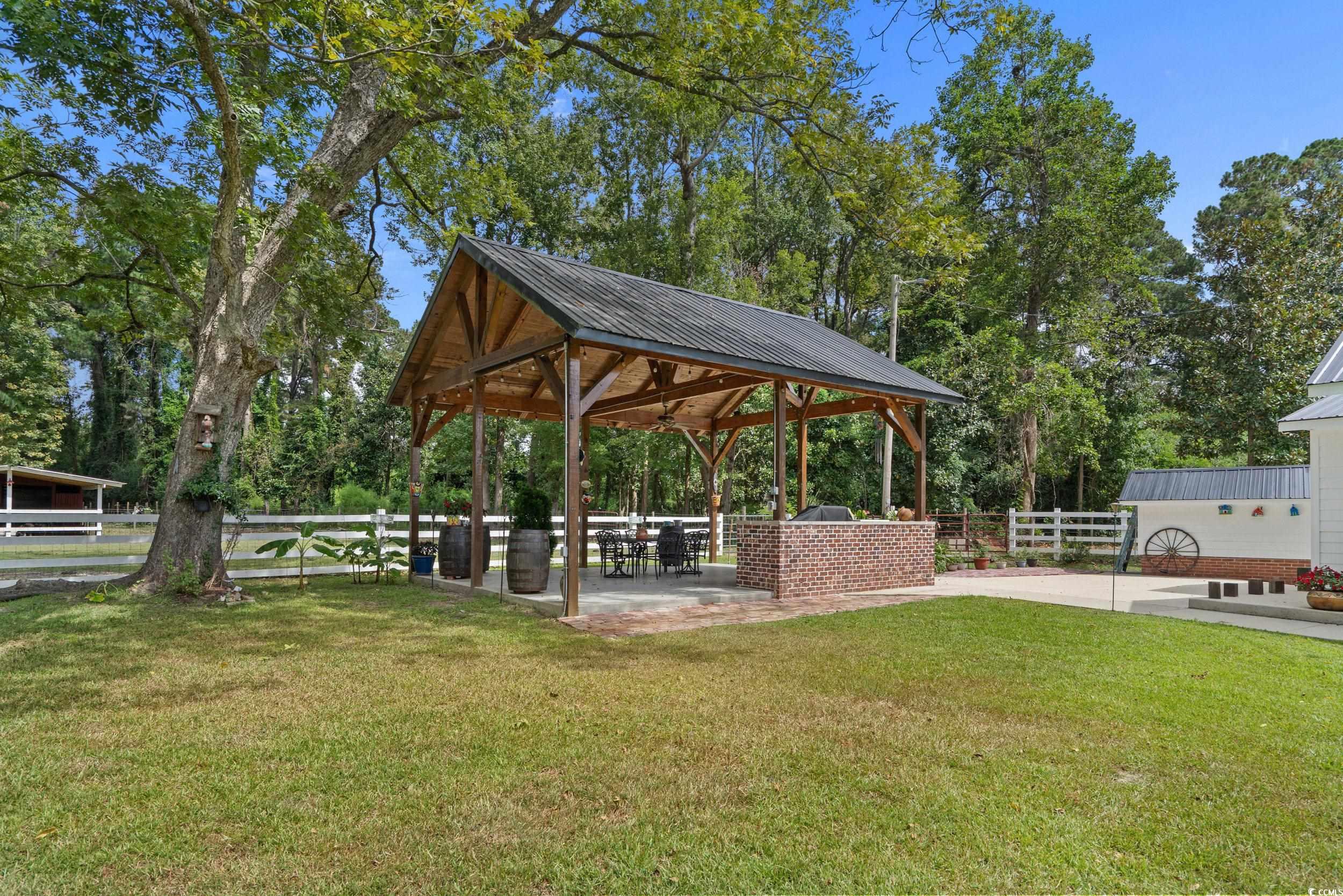 2323 Main Street Loris, SC 29569 - Photo 12 of 40 View of home's community with a patio area and view of scattered trees