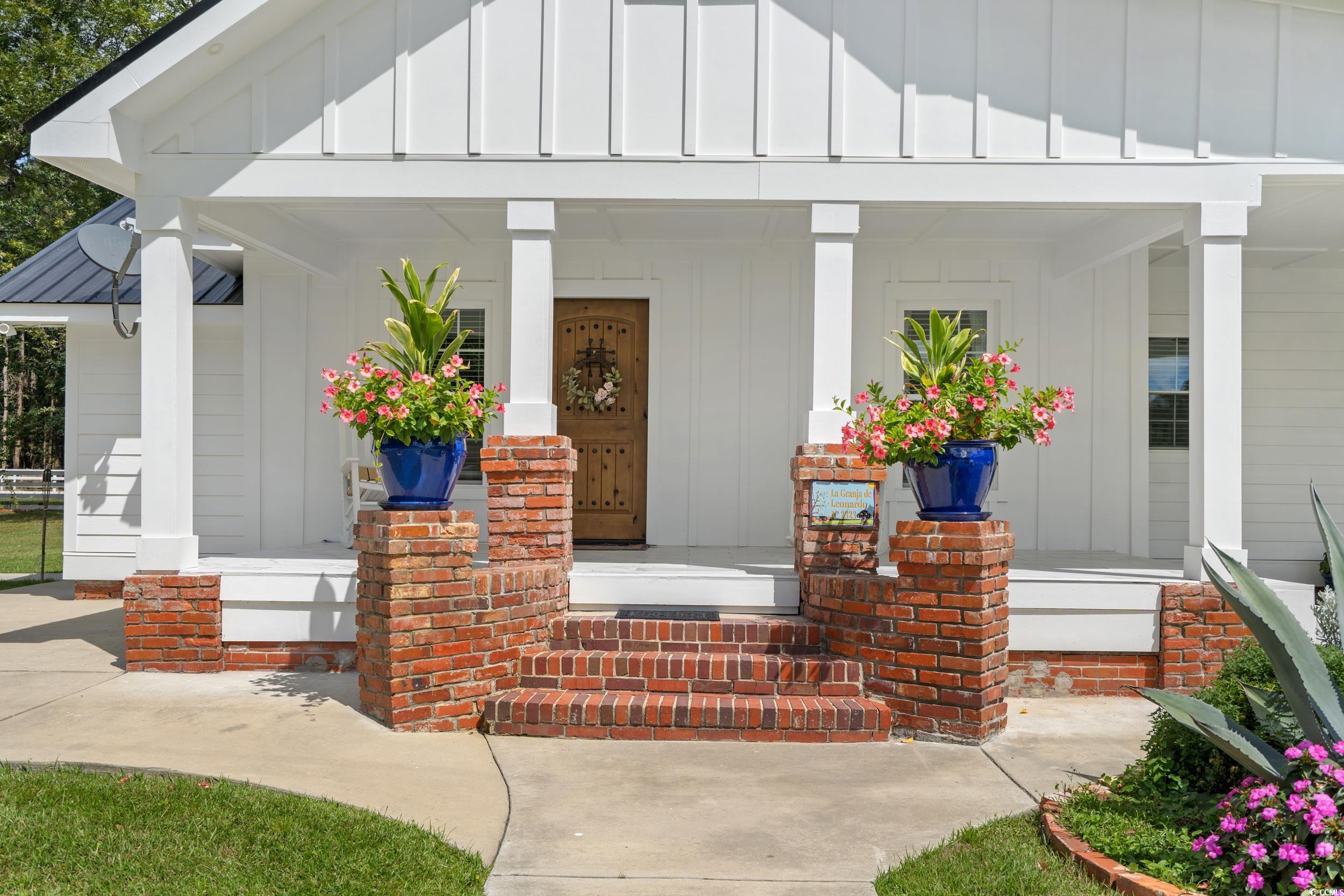 2323 Main Street Loris, SC 29569 - Photo 17 of 40 View of exterior entry featuring board and batten siding and covered porch