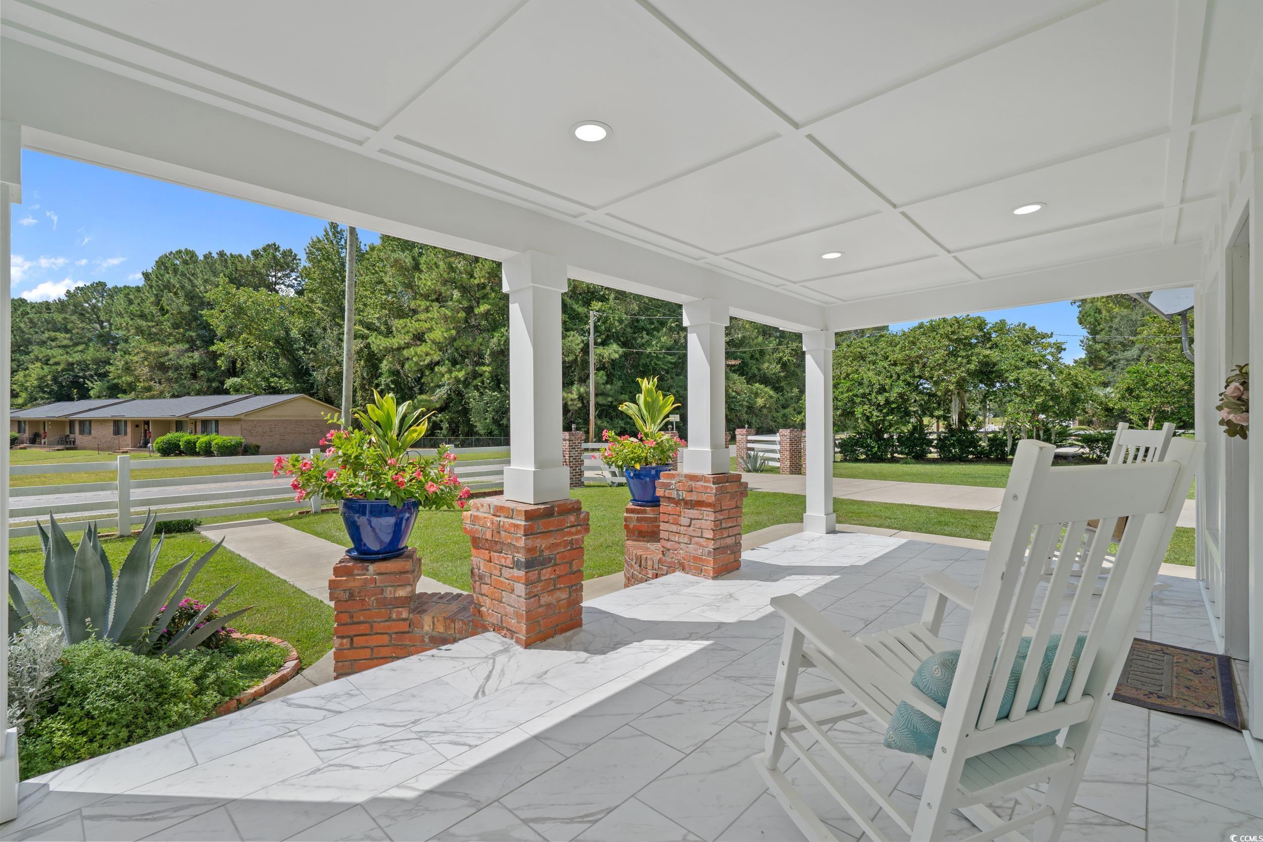 2323 Main Street Loris, SC 29569 - Photo 19 of 40 Covered porch featuring a yard