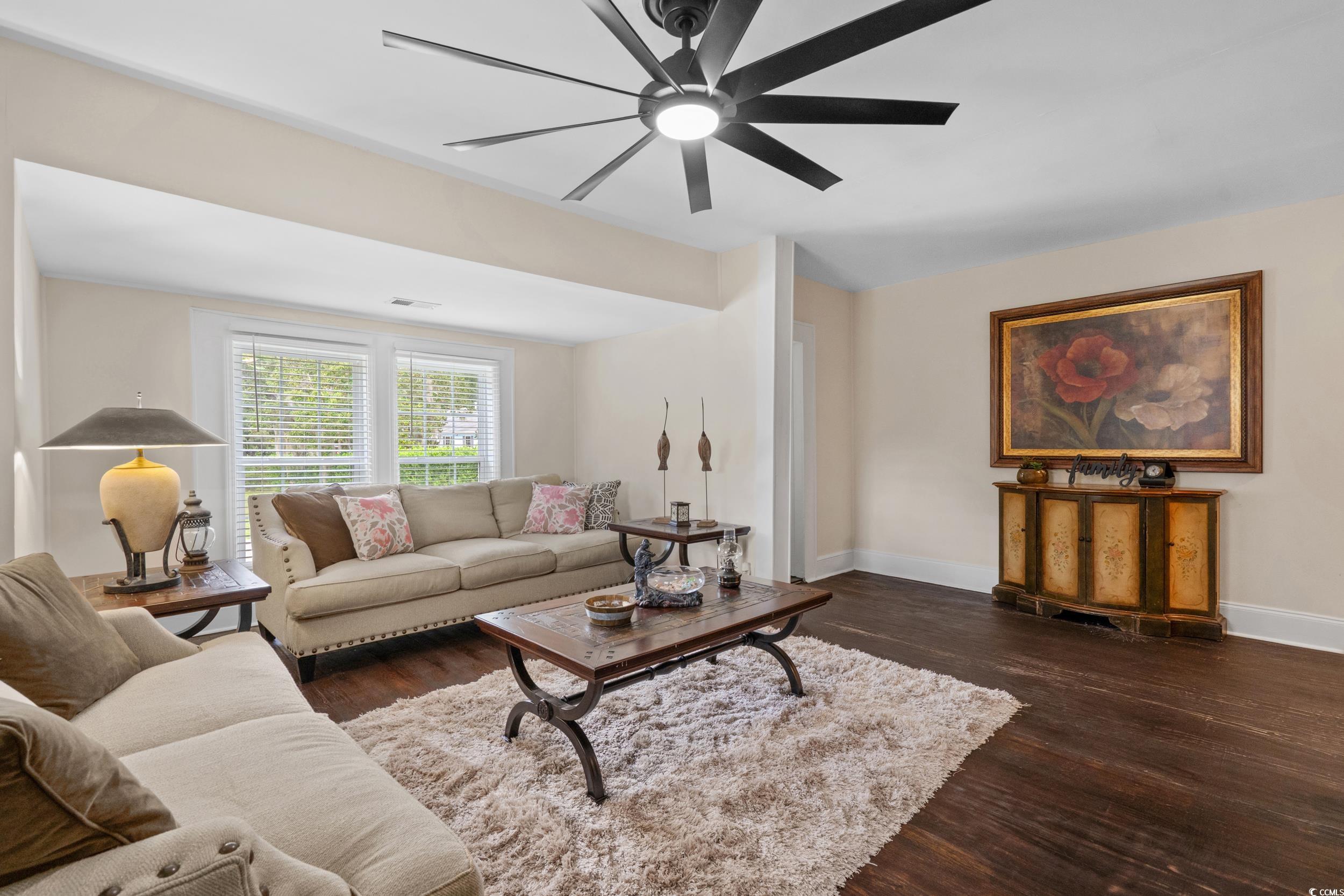 2323 Main Street Loris, SC 29569 - Photo 22 of 40 Living area featuring dark wood-style floors and ceiling fan