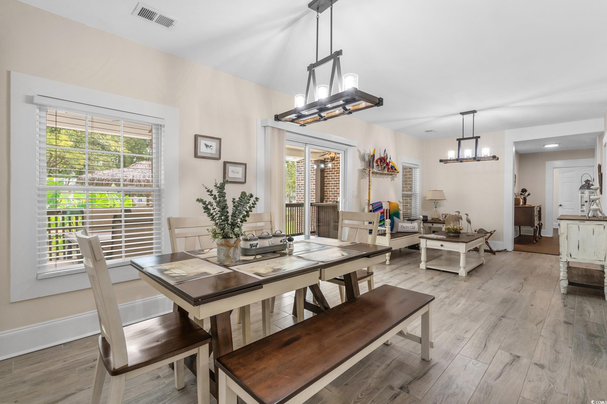 2323 Main Street Loris, SC 29569 - Photo 26 of 40 Dining room featuring light wood finished floors and a chandelier
