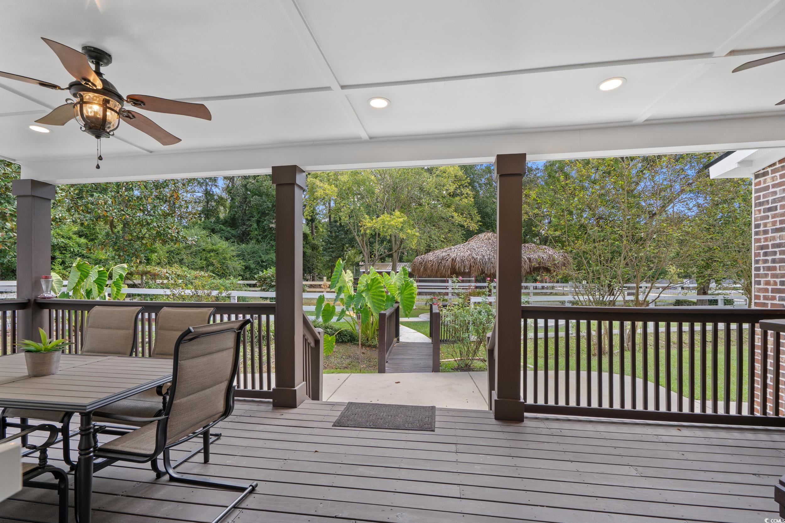 2323 Main Street Loris, SC 29569 - Photo 30 of 40 Wooden terrace with ceiling fan and outdoor dining area