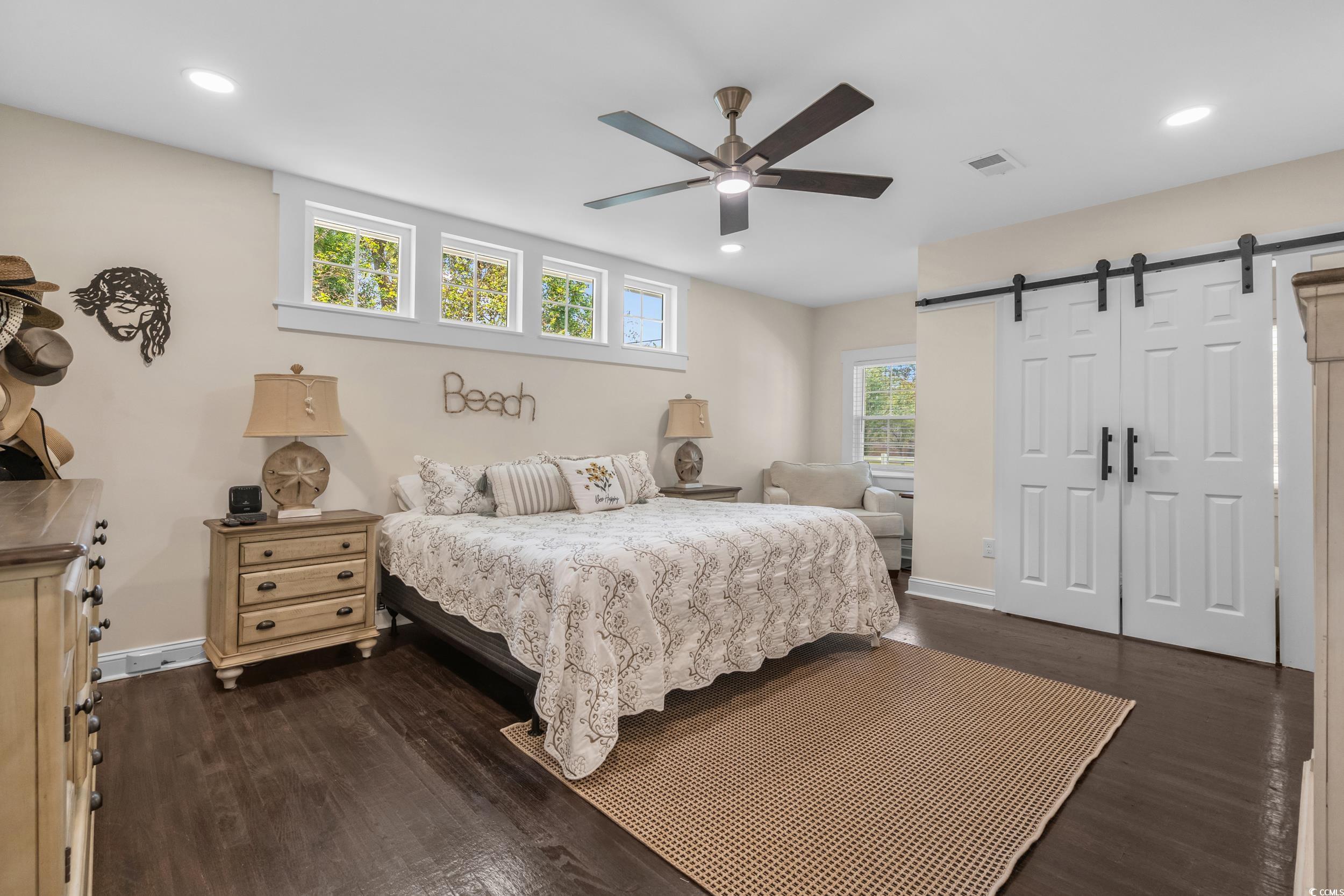 2323 Main Street Loris, SC 29569 - Photo 31 of 40 Bedroom featuring a barn door, dark wood-style flooring, ceiling fan, and recessed lighting