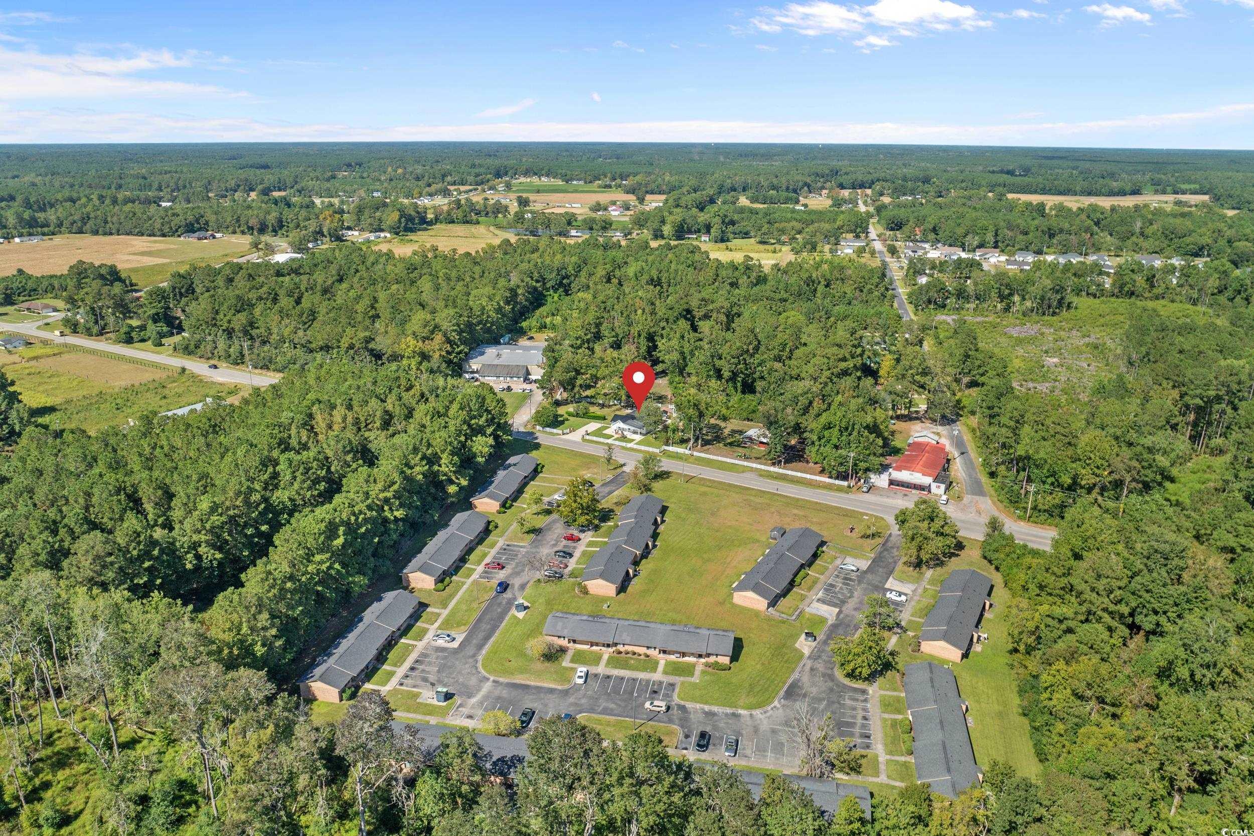 2323 Main Street Loris, SC 29569 - Photo 39 of 40 Aerial view of property and surrounding area with a heavily wooded area
