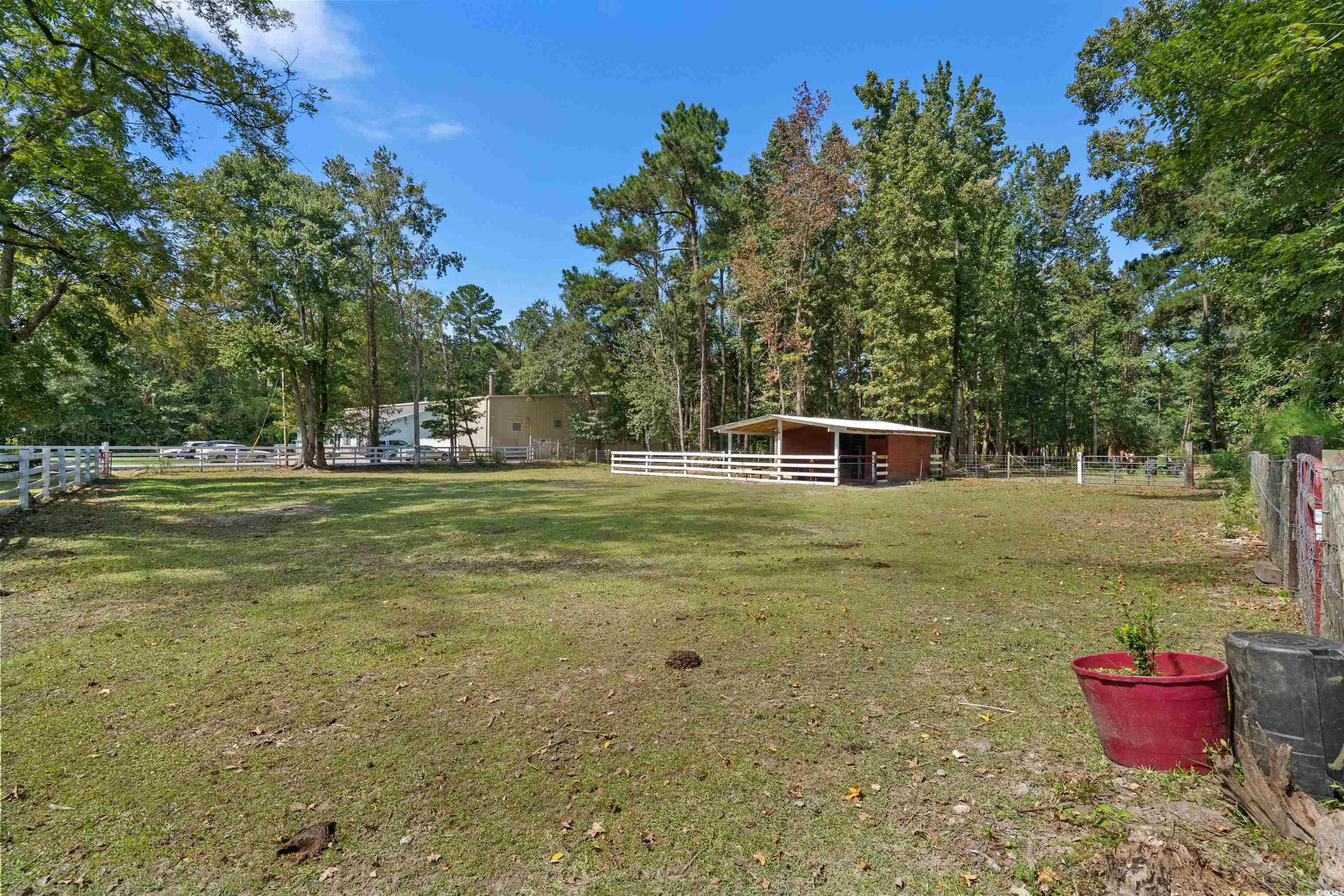 2323 Main Street Loris, SC 29569 - Photo 7 of 40 View of yard featuring an outbuilding, an exterior structure, and a view of rural / pastoral area
