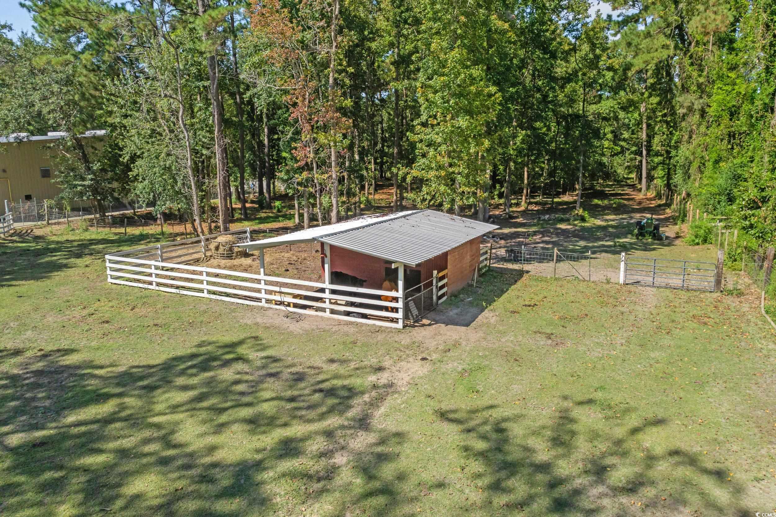 2323 Main Street Loris, SC 29569 - Photo 8 of 40 View of yard with an exterior structure, an outbuilding, and a view of rural / pastoral area