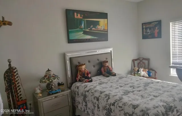 a bedroom with a bed and a mirror