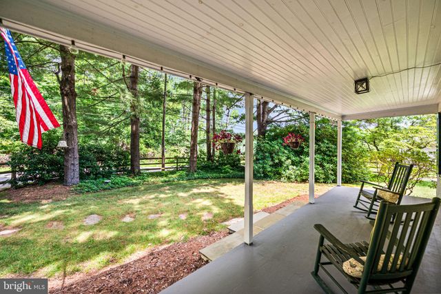 a view of a patio with a table chairs and a backyard
