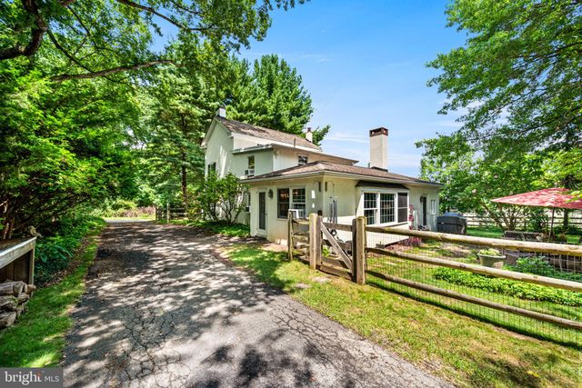 a front view of a house with a yard table and chairs