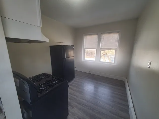 a view of kitchen with a refrigerator and wooden floor