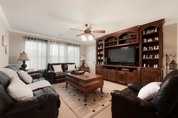 a living room with furniture kitchen view and a chandelier
