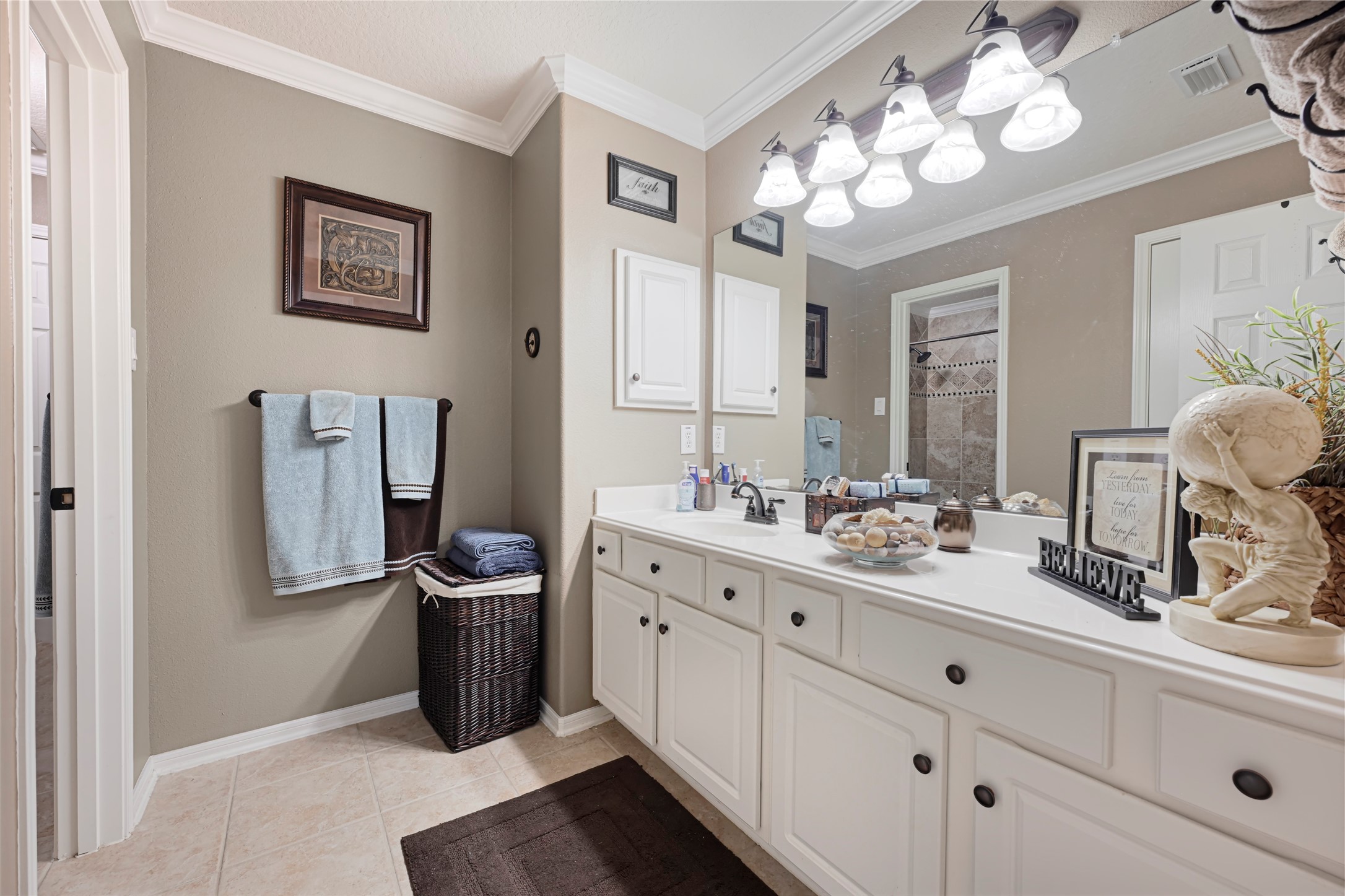 15306 Progress Ridge Way Cypress, TX 77429 - Photo 24 of 37 a bathroom with a double vanity sink mirror and chandelier