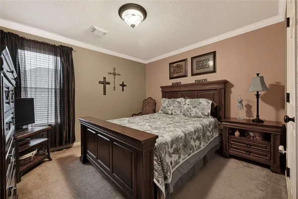 a bedroom with a bed and windows