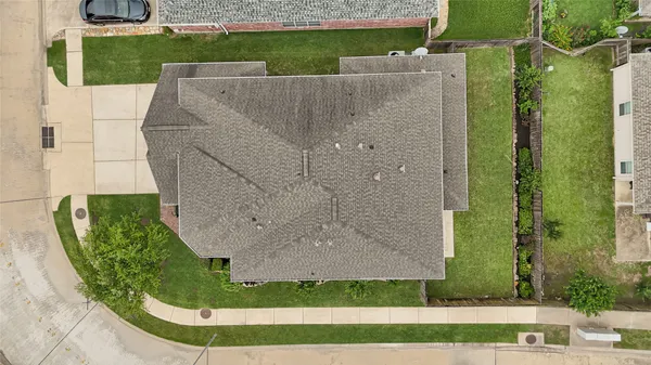 an aerial view of a house with a yard