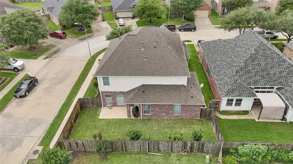 an aerial view of a house with a garden and trees