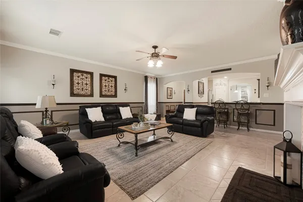 a living room with a fireplace and a chandelier