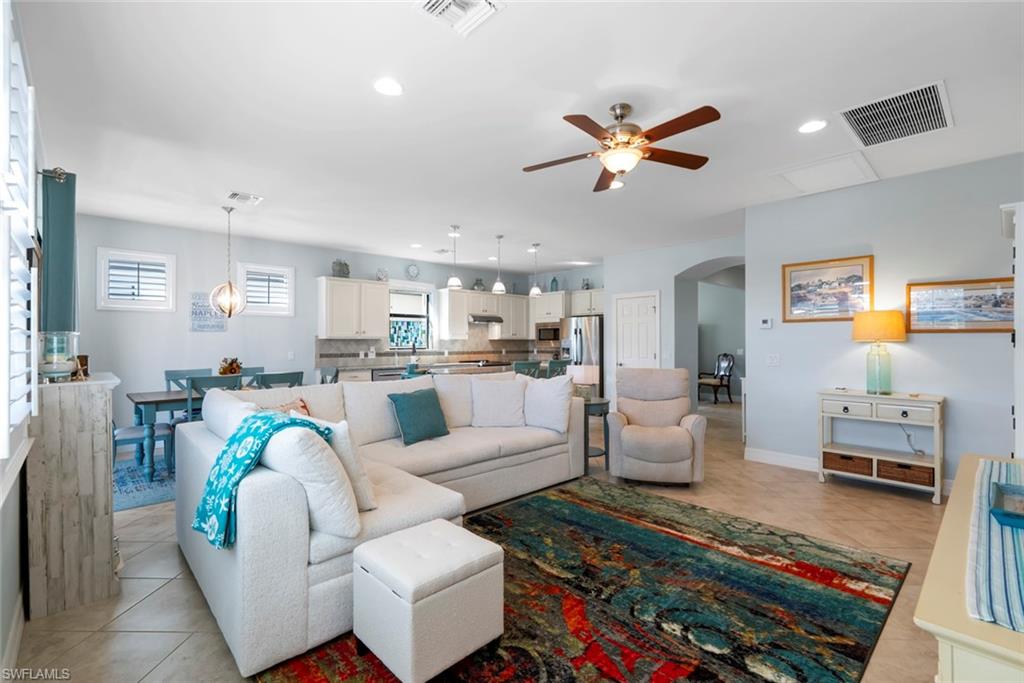 6264 Victory Drive Immokalee, FL 34142 - Photo 12 of 44 a living room with furniture and kitchen view