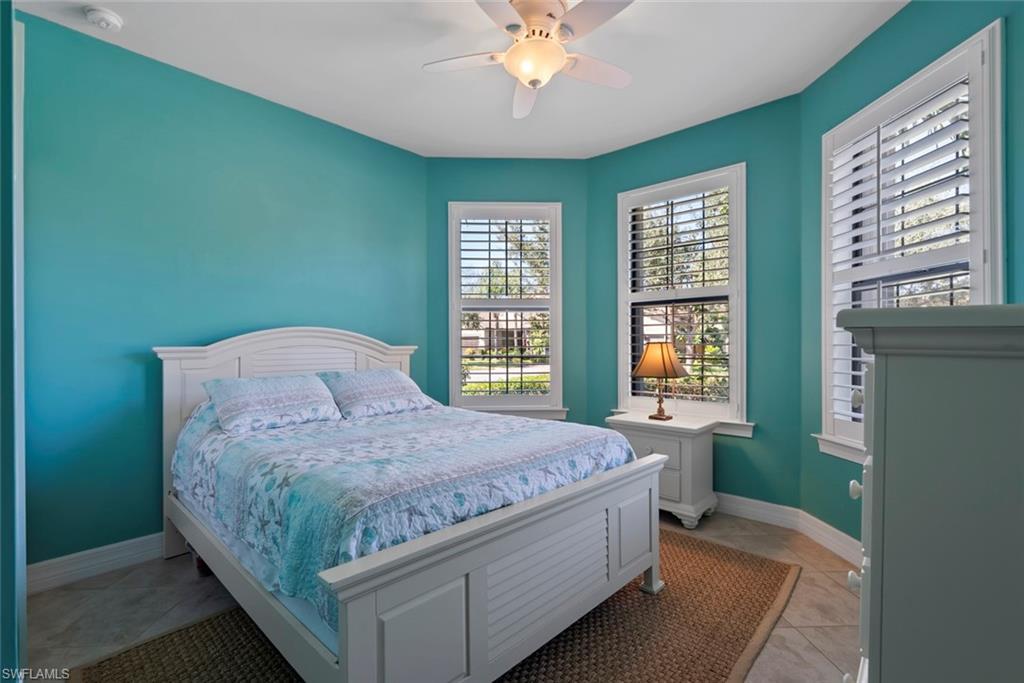 6264 Victory Drive Immokalee, FL 34142 - Photo 17 of 44 a bed sitting in a spacious bedroom next to a window