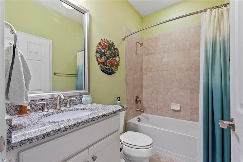 6264 Victory Drive Immokalee, FL 34142 - Photo 18 of 44 a bathroom with a granite countertop sink toilet and shower