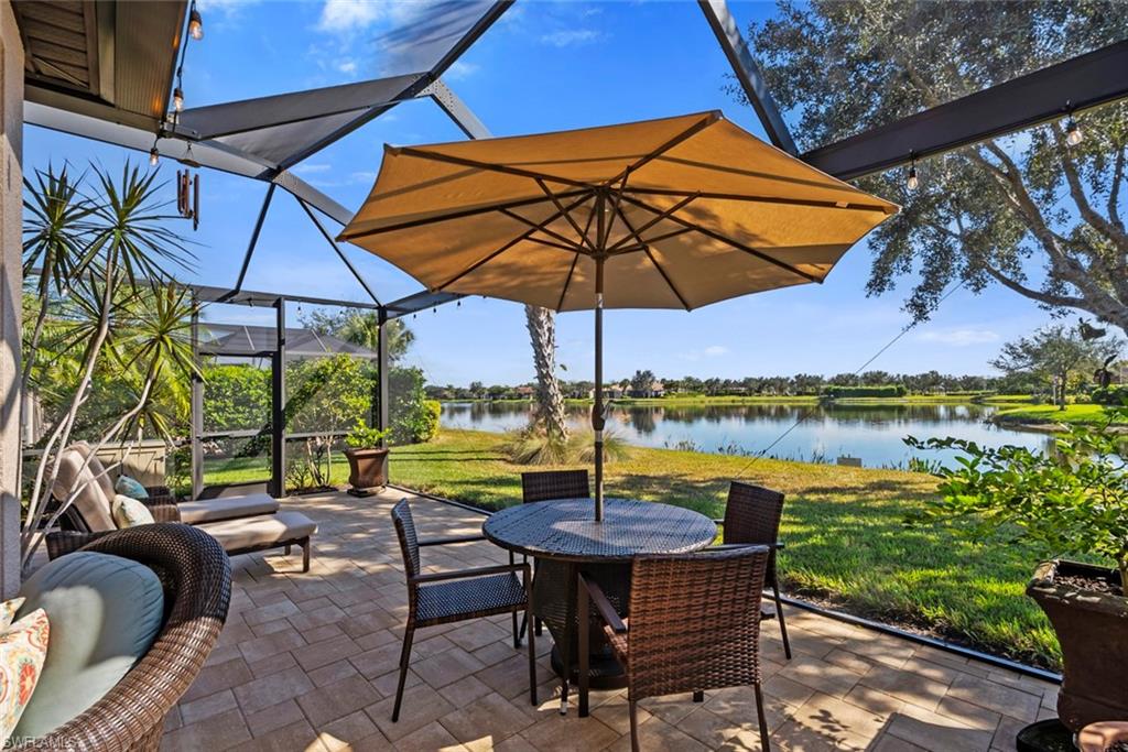6264 Victory Drive Immokalee, FL 34142 - Photo 23 of 44 a view of swimming pool with a table and chairs under an umbrella