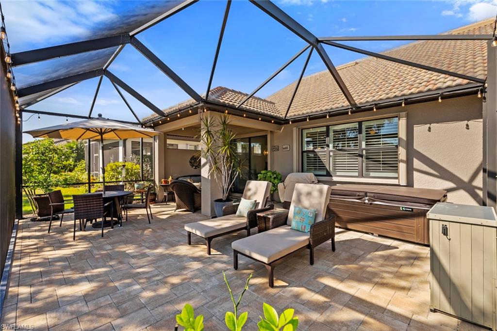 6264 Victory Drive Immokalee, FL 34142 - Photo 24 of 44 a outdoor space with patio the couches and pool table and chairs under an umbrella