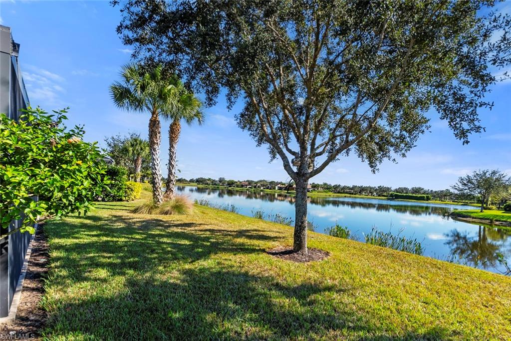 6264 Victory Drive Immokalee, FL 34142 - Photo 26 of 44 a view of a lake with a big yard and potted plants