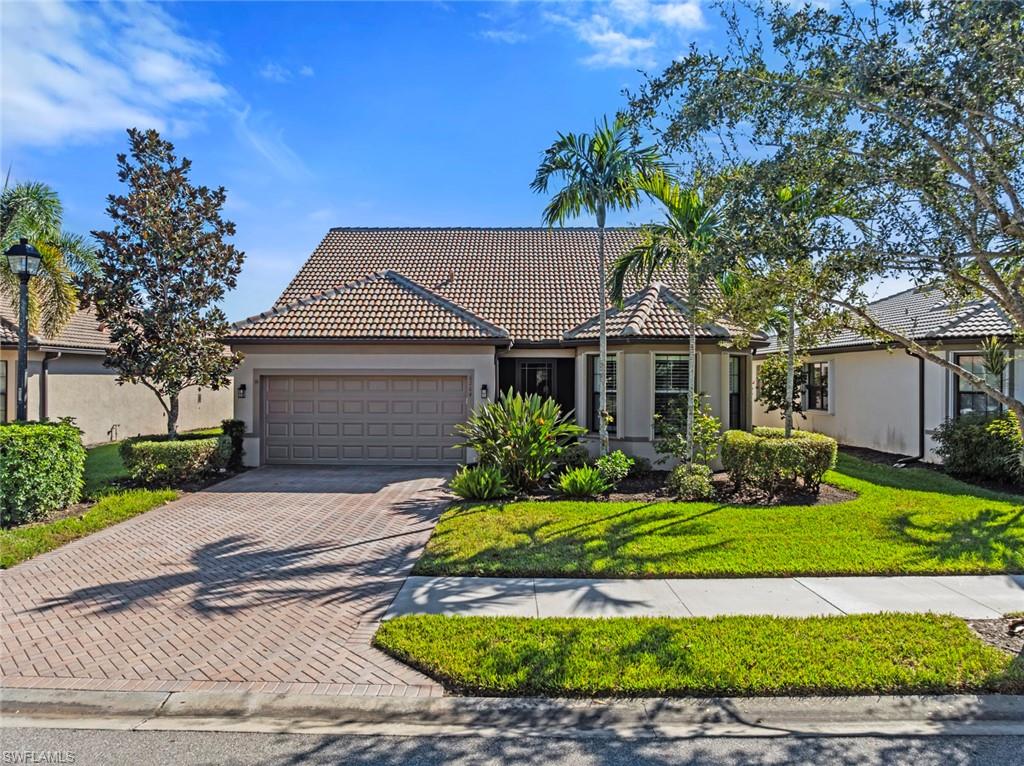 6264 Victory Drive Immokalee, FL 34142 - Photo 31 of 44 a front view of a house with a yard