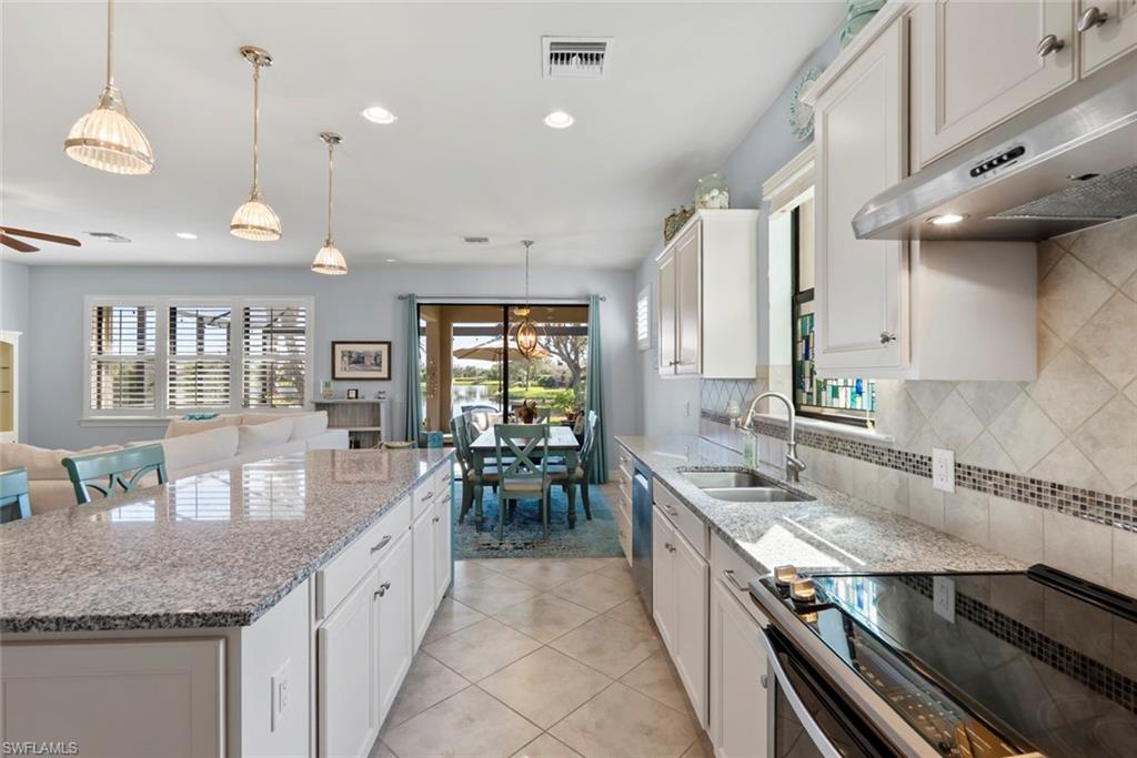 6264 Victory Drive Immokalee, FL 34142 - Photo 8 of 44 a large kitchen with granite countertop lots of counter space and a sink