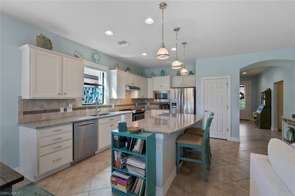 6264 Victory Drive Immokalee, FL 34142 - Photo 9 of 44 a large kitchen with a table and chairs