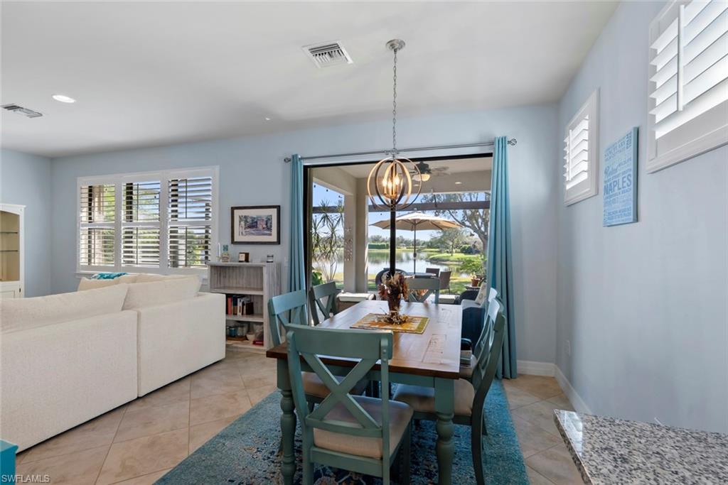 6264 Victory Drive Immokalee, FL 34142 - Photo 10 of 44 a dining room with furniture a chandelier and wooden floor