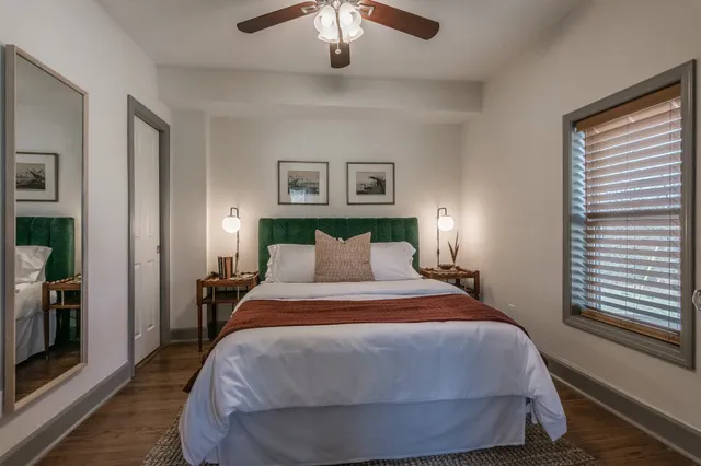 a bedroom with a bed and a chandelier