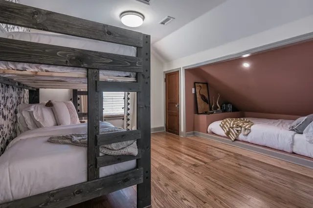 a bedroom with furniture and wooden floor